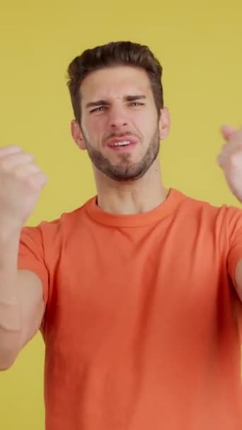 Happy Caucasian Man Celebrating While Raising Fists Studio Yellow Background — 비디오