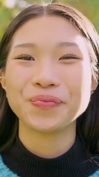 Slow Motion Video Smiling Asian Woman Looking Camera Park — Vídeos de Stock