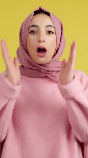 Surprised Muslim Woman Hijab Looking Camera Studio Yellow Background — Stockvideo