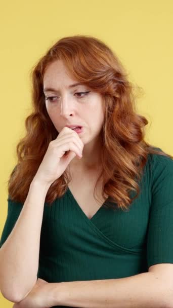 Redheaded Woman Hand Face Thoughtful Expression Studio Yellow Background — Stock Video