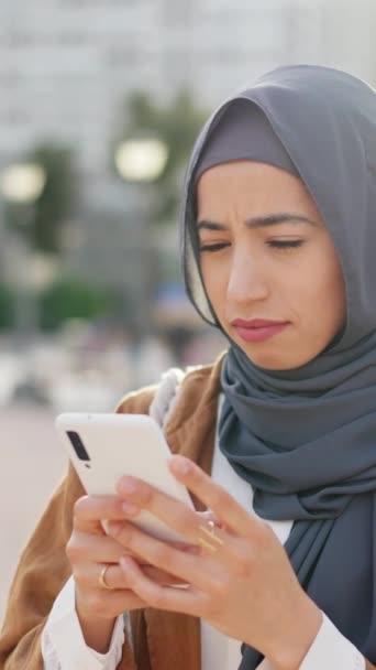 Muslim Woman Hijab Using Mobile Phone Expression Disgust Exasperation Outdoors — Stockvideo