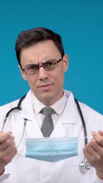 Physician White Robe Stethoscope Frowning Looking Camera Blue Background While — 비디오