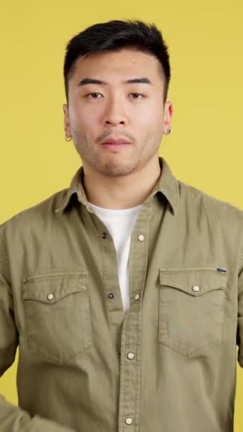 Serious Chinese Man Standing Crossed Arms Looking Camera Studio Yellow — Wideo stockowe