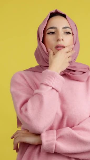 Worried Muslim Woman Looking Away Pensive Expression Studio Yellow Background — Stockvideo