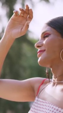 Transgender woman dancing softly in a park