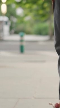 Profile of a muslim woman walking while using the mobile outdoors
