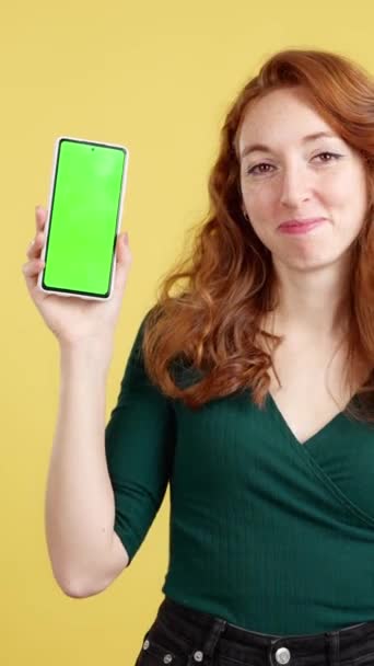 Roodharige Vrolijke Vrouw Presenteren Een Mobiel Met Een Chroma Scherm — Stockvideo