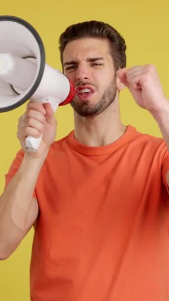 Upset Caucasian Man Yelling Using Loudspeaker Studio Yellow Background — Stock Video