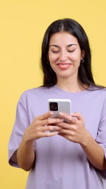 Happy Caucasian Woman Smiling While Using Mobile Studio Yellow Background — 图库视频影像