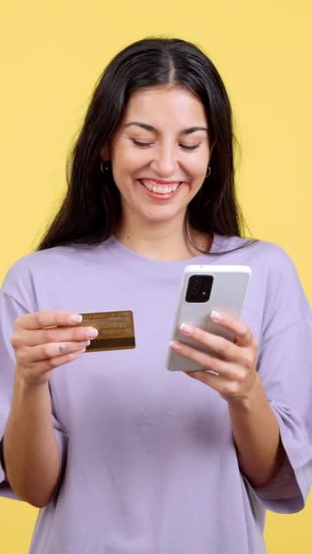 Happy Woman Using Mobile Card Shopping Online Studio Yellow Background — Stock videók