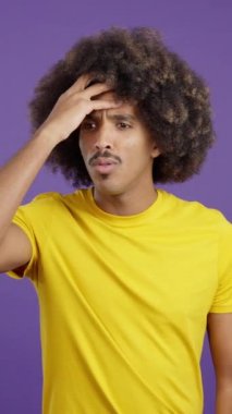 Desperate african man gesturing that he is forgetting something in studio