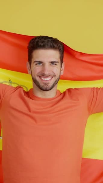 Happy Caucasian Man Smiling Raising Spanish National Flag Studio Yellow — 图库视频影像