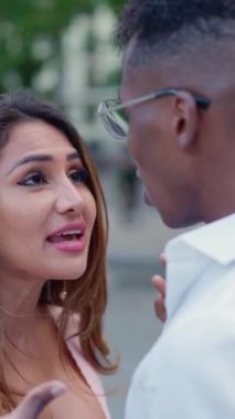 Multiethnic couple arguing and yelling in the public space