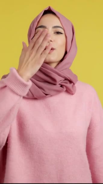 Muslim Woman Blowing Kiss While Looking Camera Studio Yellow Background — Stock Video