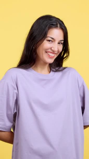 Happy Woman Looking Camera Giving Present Studio Yellow Background — Stockvideo