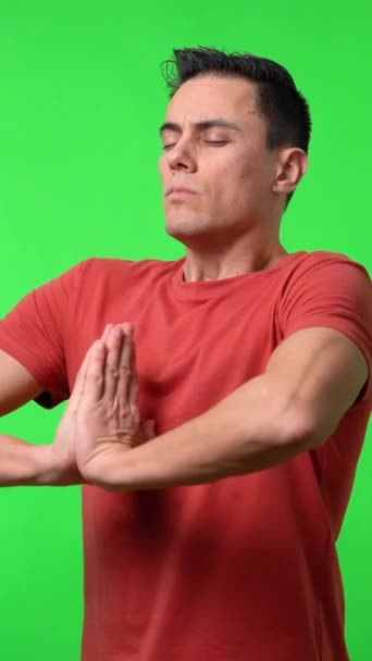 Man Meditating His Eyes Closed Chroma Green Background Red Shirt — Stock Video