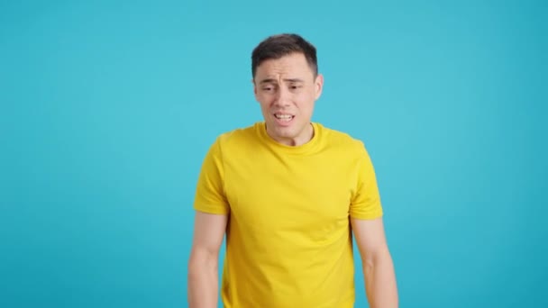 Video Studio Blue Background Desperate Man Looking Camera While Having — Stock Video
