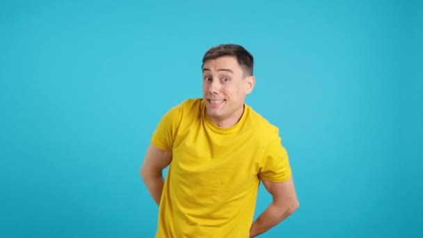 Video Studio Blue Background Man Throws Confetti Himself Smiles Ecstasy — Stock Video