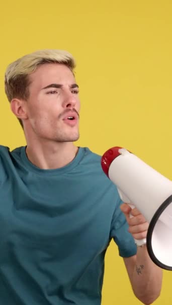Angry Gay Man Yelling Using Megaphone Studio Yellow Background — Stock Video