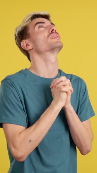 Gay Man Praying Folded Hands Looking Studio Yellow Background — Stock Video