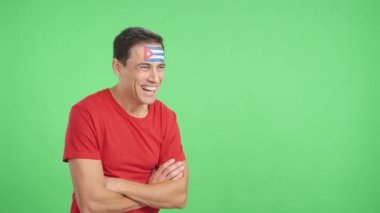 Stüdyoda, yüzünde Küba bayrağı olan mutlu bir adamın, boş bir şekilde fotokopi odasına bakışını gösteren bir video var.