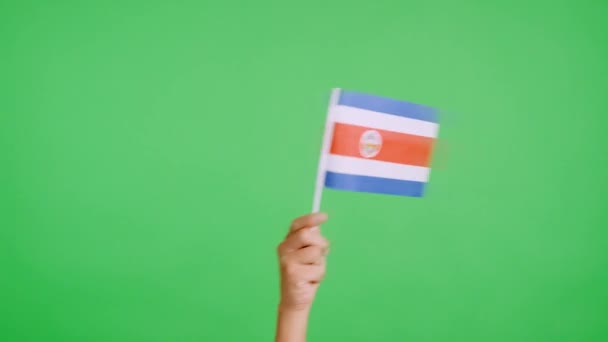 スタジオでのスローモーションビデオ コスタリカの国旗のペナントを横から横に振る手のクロマ — ストック動画