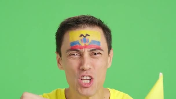 影片在演播室里的彩色特写是一名男子的近照 他的脸上挂着一面横幅 支持厄瓜多尔队 — 图库视频影像