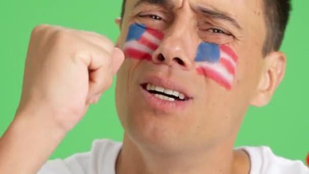 얼굴에 그려진 국기를 남자의 크로마와 스튜디오에서 비디오를 닫습니다 어려운 — 비디오