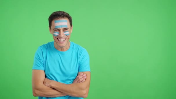 スタジオでのビデオ クロマ 腕と顔に笑顔で描かれたアルゼンチンの旗と立っている男の — ストック動画