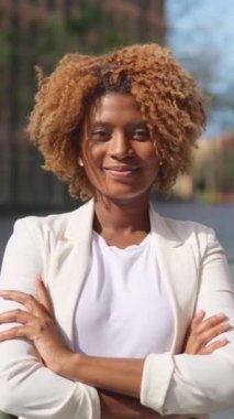 Gülümseyen Afrikalı bir iş kadınının sokakta silah çekerken videosu.