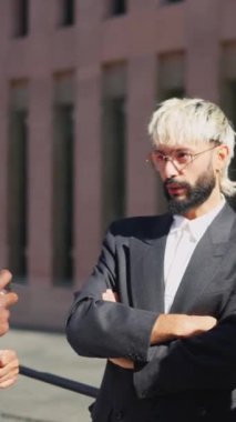 Finansal bölgede rahatça konuşan bir grup çok ırklı iş adamının videosu.