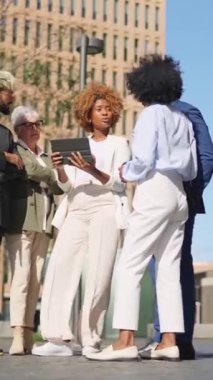 Dijital tablet kullanan çok ırklı iş adamlarının yan yana seyahat ettiği video