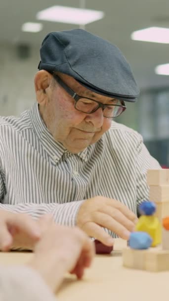 Πολύ Συγκεντρωμένος Ηλικιωμένος Άντρας Αποσυναρμολογεί Κομμάτια Ξύλου Ένα Γηροκομείο — Αρχείο Βίντεο
