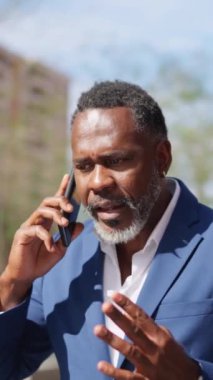 Bir Afrikalı iş adamının videosu açık havada telefonla konuşurken koşmaya başlıyor.