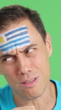 Stüdyoda, yüzünde uruguay bayrağı olan çok gergin bir adamın krom rengiyle, zor bir maçta Uruguay takımını destekleyen ve sonunda kaybedilen bir adamın videosunu kapat.