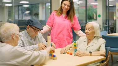 Friendly nurse talking to senior people in the nursing home clipart