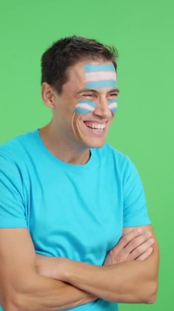 Видео Студии Хромой Счастливого Человека Аргентинским Флагом Нарисованным Лице Смотрящего — стоковое видео