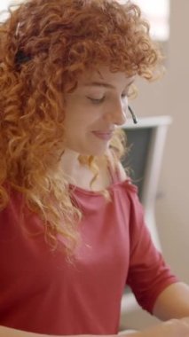 Ofiste oturan bir müşteriyle konuşan çekici bir kadın tele operatörün yavaş çekim videosu.