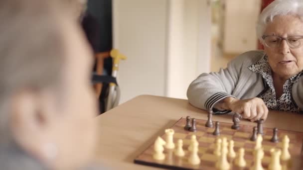 Slow Motion Video Two Female Senior Friends Playing Chess Nursing — Stock Video