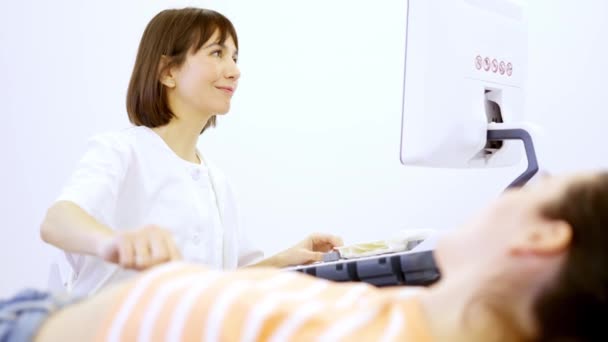 Hamile Bir Kadına Ultrason Yapılırken Gülümseyen Neşeli Bir Kadın Doktor — Stok video