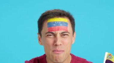 Venezuela bayrağıyla Venezuela takımını destekleyen bir adamın krom görüntüsü stüdyoda.