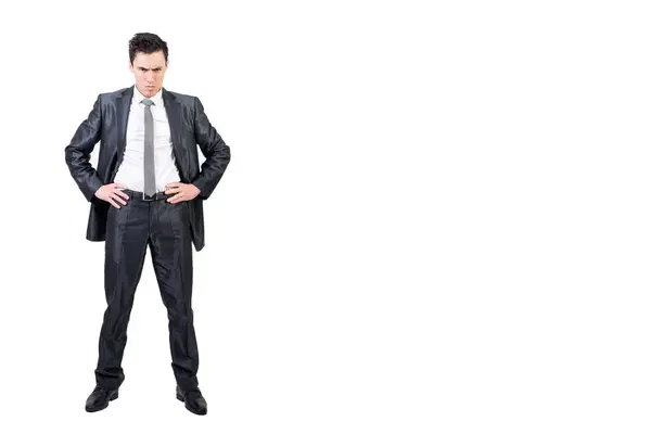 Stock image Full body of confident male in formal suit looking at camera with serious face and hands on waist isolated on white background