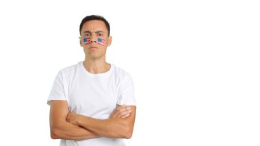 Onurlu ve ciddi bir adam yüzünde Amerikan bayrağı ile kameraya onurlu bir şekilde bakıyor.