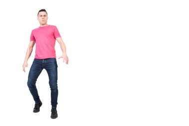 Full body of confused male looking at camera with concerned gaze while standing isolated on white background in light studio clipart