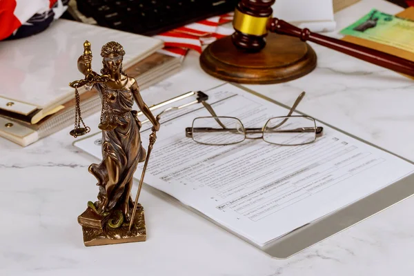 It is justice statue on law in court gavel with document folder by administration, next to lawyer desk