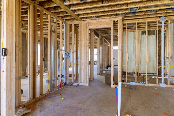 Installation of mineral fiberglass wool between beams to be used in constructing wall is intended to provide thermal and sound insulation