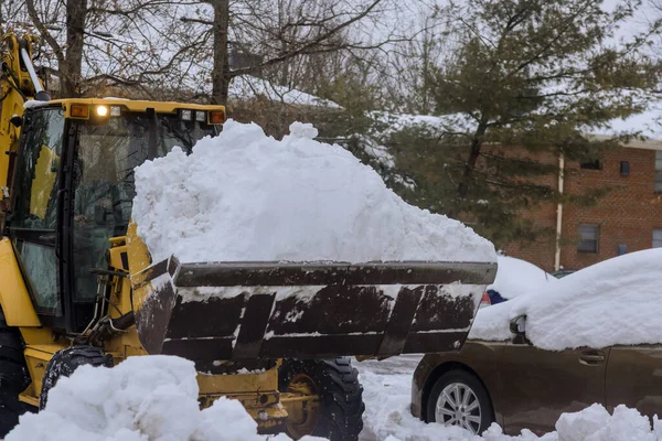 Clean up of snow with tractor after huge snowstorm in winter time after snow blizzard has occurred
