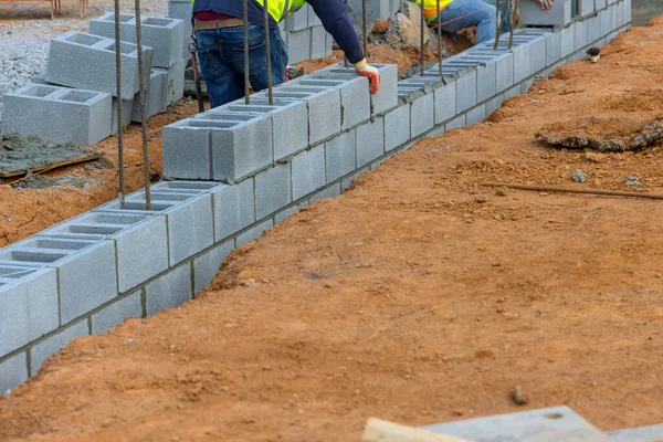 Worker Placing Cement Blocks Another Row Bricks Bricklaying Construction Site — Stock Photo, Image