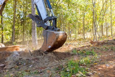 Traktörlerin kayma dümenleri, konut geliştirme bölümünün hazırlanması için geniş araziyi köklerinden temizlemek için kullanıldı.