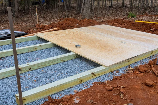 To build wooden deck foundation in backyard to support small shed